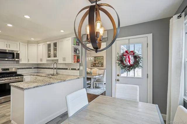 a open kitchen with stainless steel appliances granite countertop a stove and a sink
