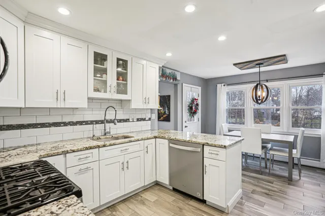 a kitchen with a sink stove and cabinets