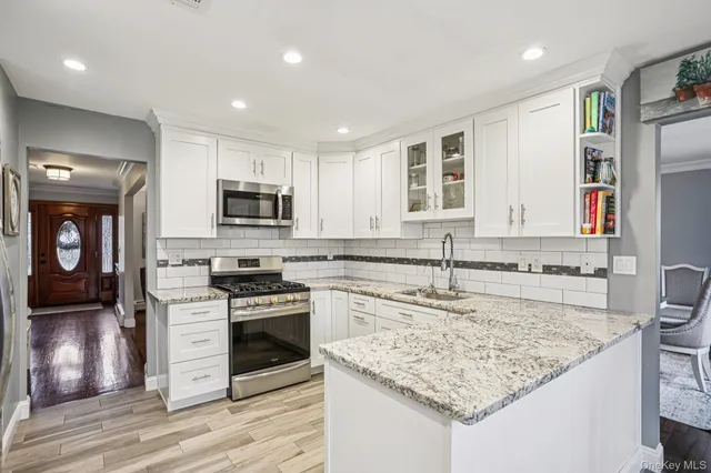 a kitchen with a sink stove top oven and refrigerator