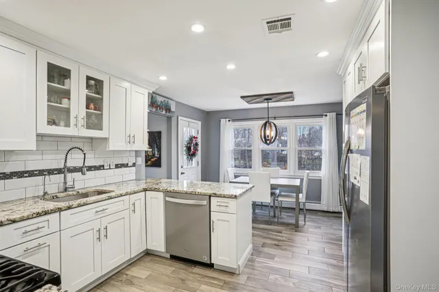 a kitchen with sink stove and cabinets