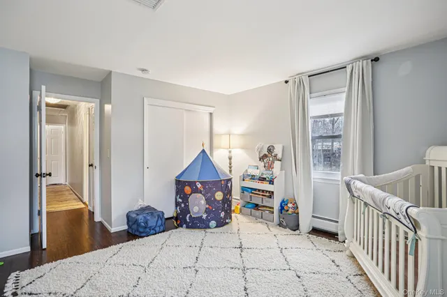 a bedroom with furniture and a window