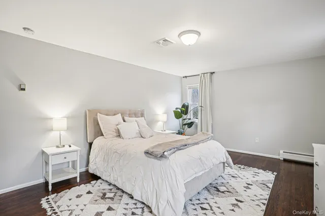 a bedroom with a bed and a lamp on table