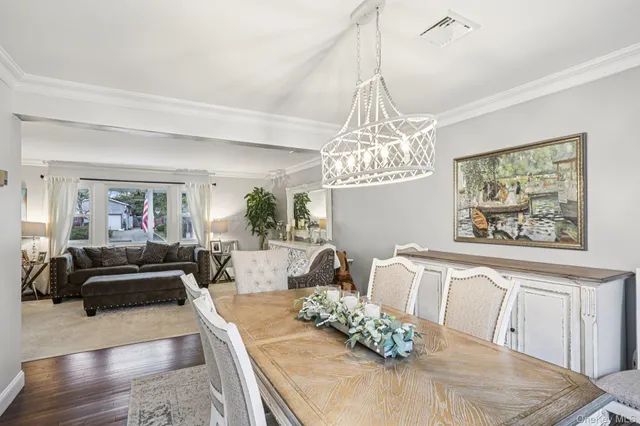 a living room with furniture chandelier and a chandelier