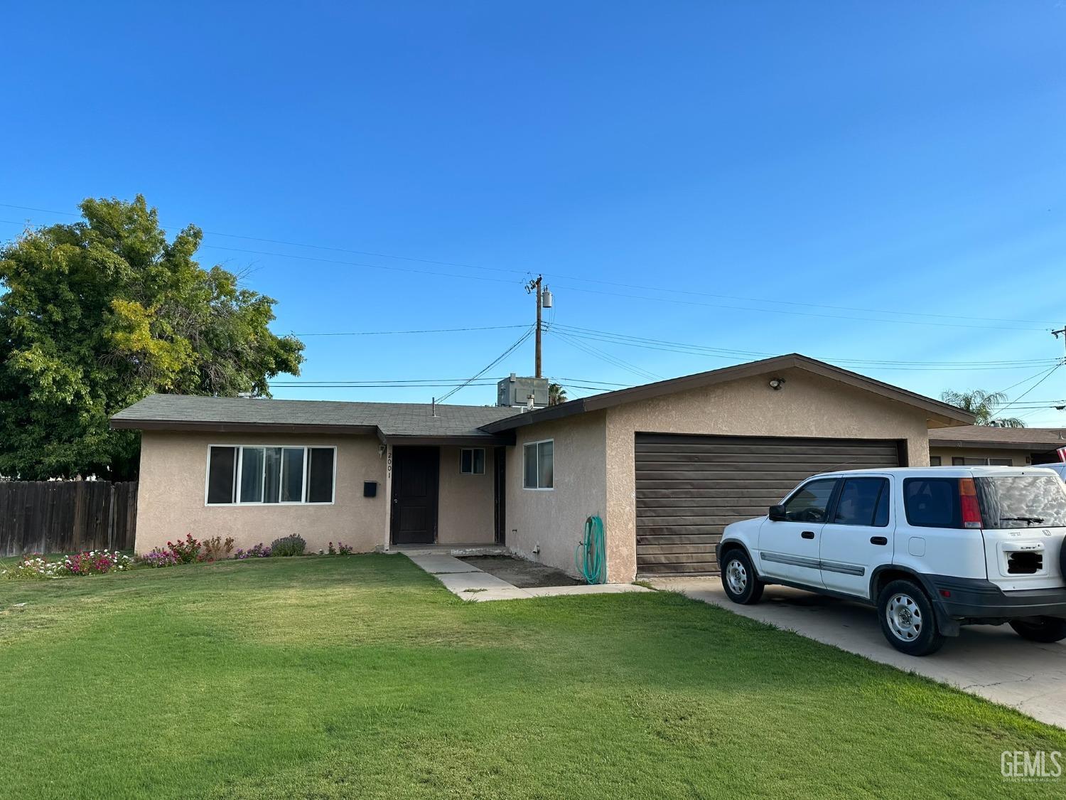 Undisclosed Address Delano, CA 93215 - Photo 1 of 1 a front view of a house with a garden