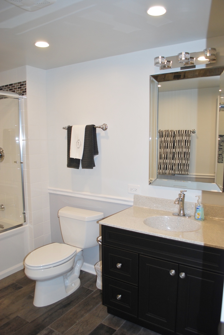 1021 South Cooper Road New Lenox, IL 60451 - Photo 22 of 25 a bathroom with a toilet a sink and mirror
