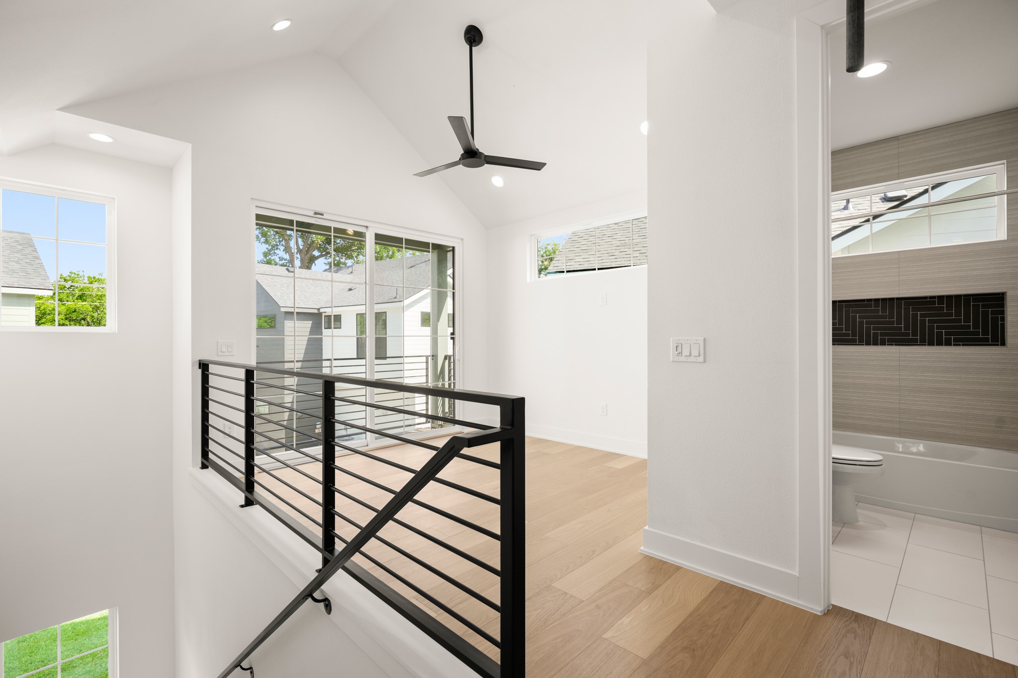 601 Vermont Road, Unit 2 Austin, TX 78702 - Photo 20 of 31 Lofty ceilings and sun-filled interiors define this inviting upper level with clear sightlines to a sleek, modern bath.