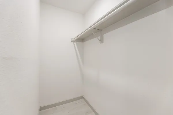 an empty room with a empty space and windows