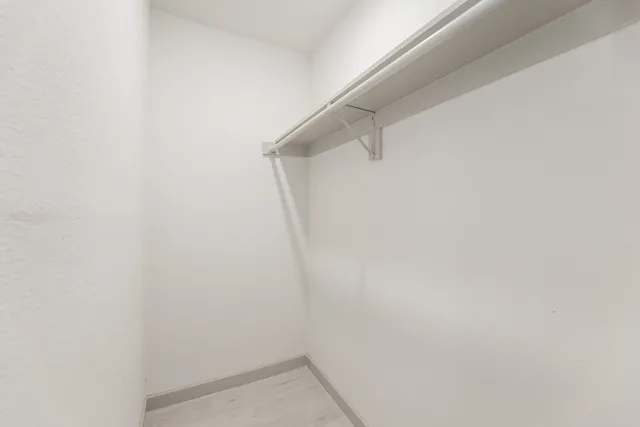 a kitchen with stainless steel appliances granite countertop a sink a stove and a wooden floors