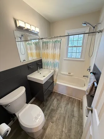 a bathroom with a sink toilet and shower