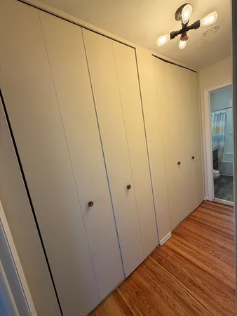 a view of a room with wooden floor