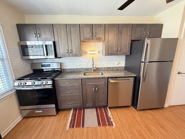 a kitchen with a sink stove and refrigerator