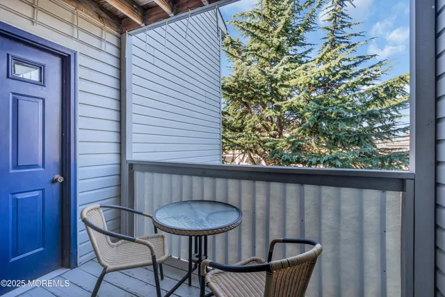 a balcony with table and chairs