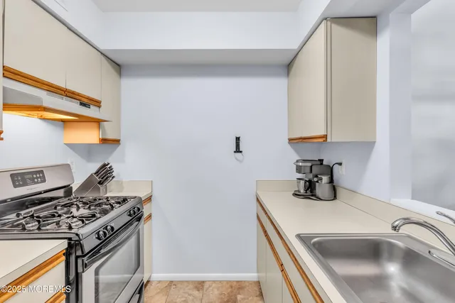 a kitchen that has a sink and a stove