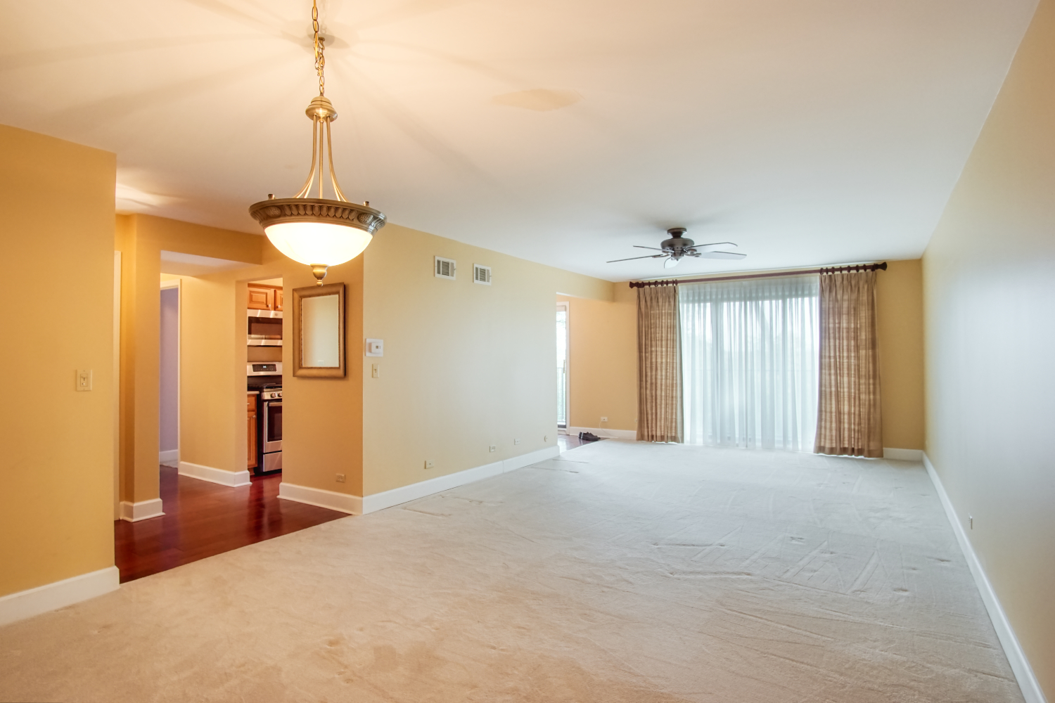 1-s150 Spring Road, Unit 4C Oak Brook, IL 60181 - Photo 8 of 17 a view of empty room with window and ceiling fan