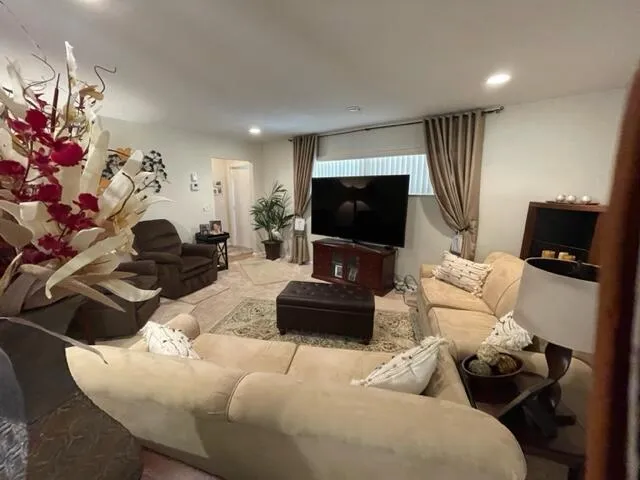 a living room with furniture and a mirror
