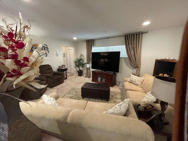 22 Colonial Club Drive, Unit 103 Boynton Beach, FL 33435 - Photo 16 of 41 a living room with furniture and a flat screen tv