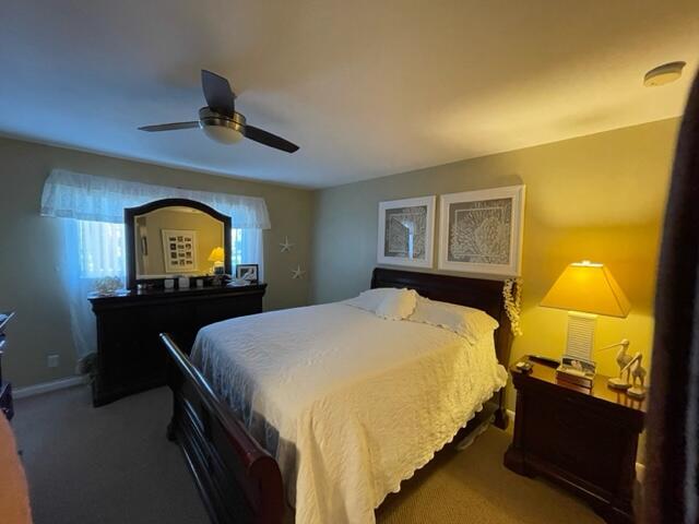 22 Colonial Club Drive, Unit 103 Boynton Beach, FL 33435 - Photo 22 of 41 a bedroom with a bed and a view of en suite bathroom