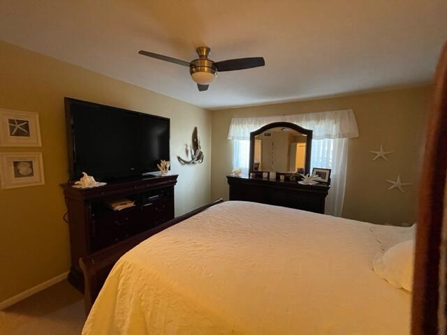 22 Colonial Club Drive, Unit 103 Boynton Beach, FL 33435 - Photo 23 of 41 a bedroom with a bed and a flat screen tv