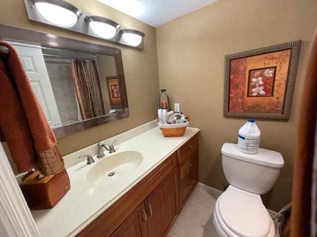 22 Colonial Club Drive, Unit 103 Boynton Beach, FL 33435 - Photo 25 of 41 a bathroom with a toilet sink and mirror