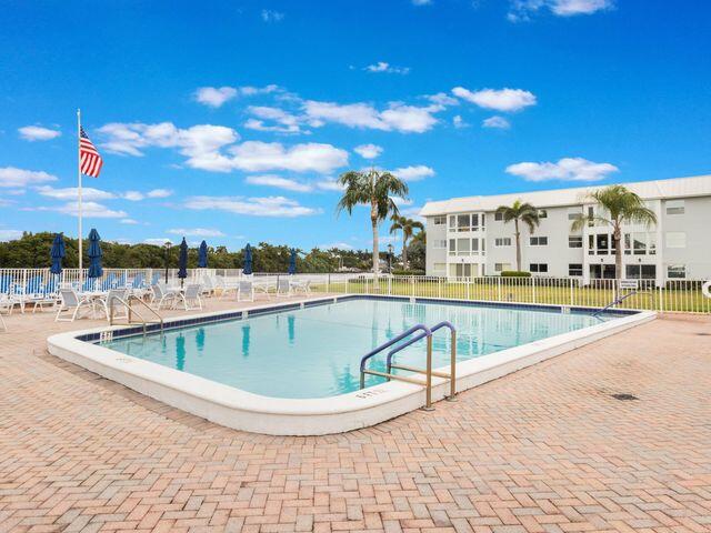 22 Colonial Club Drive, Unit 103 Boynton Beach, FL 33435 - Photo 6 of 41 a view of a swimming pool with outdoor seating