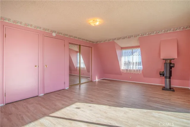 a view of a room with wooden floor and windows