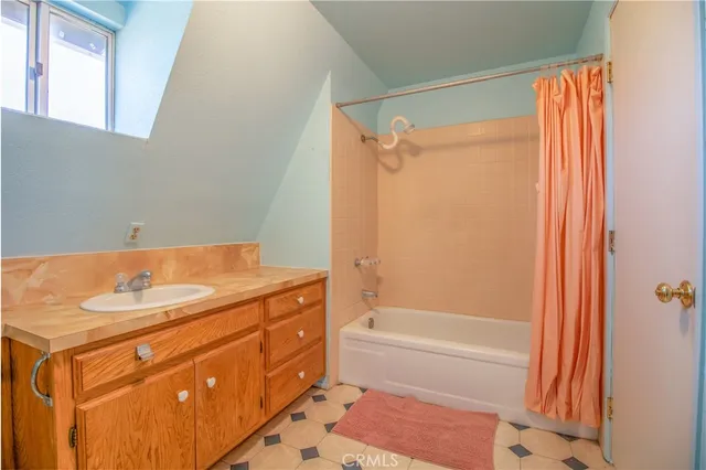 a bathroom with a sink toilet and window