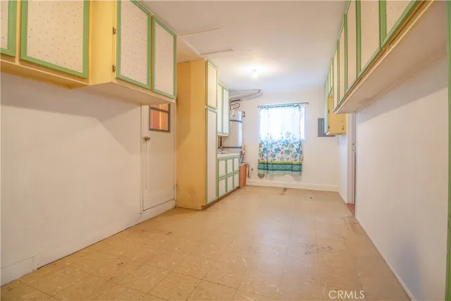 a living room filled with furniture and floor to ceiling windows