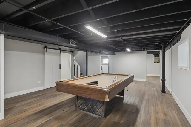 a view of a room with pool table and wooden floor