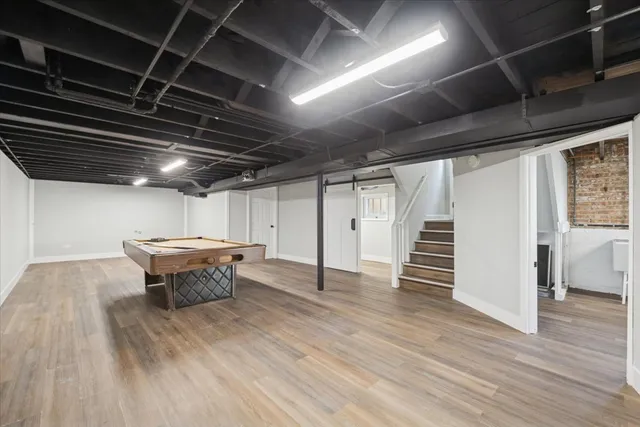 a water heater room with wooden floor