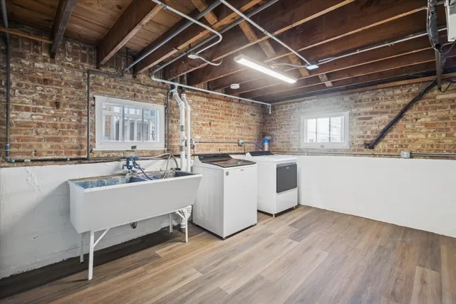 a kitchen with a sink and wooden floor