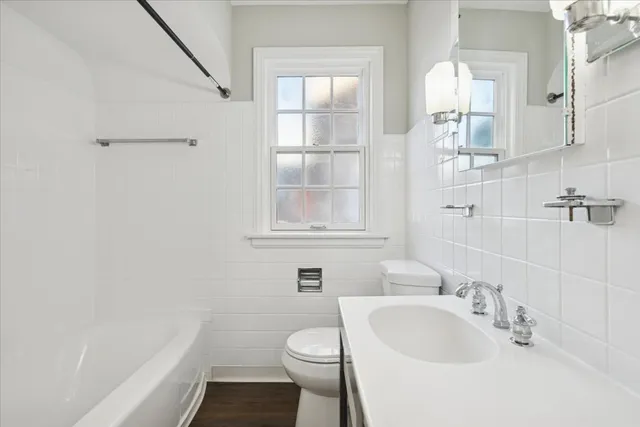 a bathroom with a sink toilet and vanity