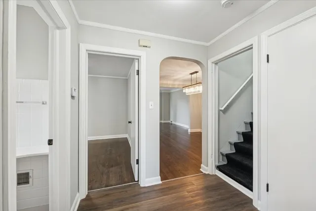 a view of a hallway with wooden floor and entryway