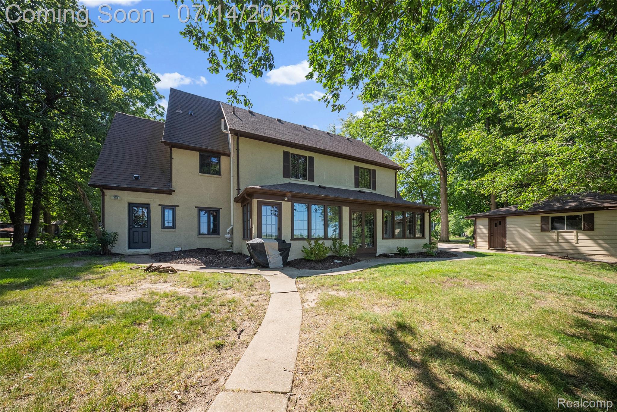 18460 Meridian Road Grosse Ile, MI 48138 - Photo 42 of 50 Two-story exterior with light-colored siding and a dark shingle roof