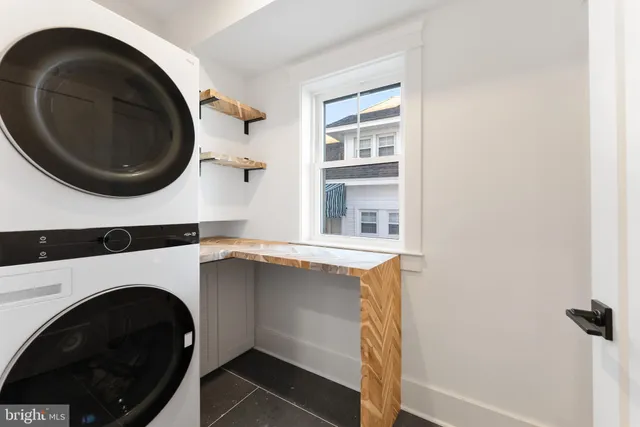 a view of a house with roof deck outdoor seating and city view
