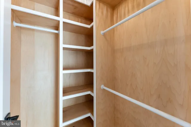 a view of a room with wooden floor and a window