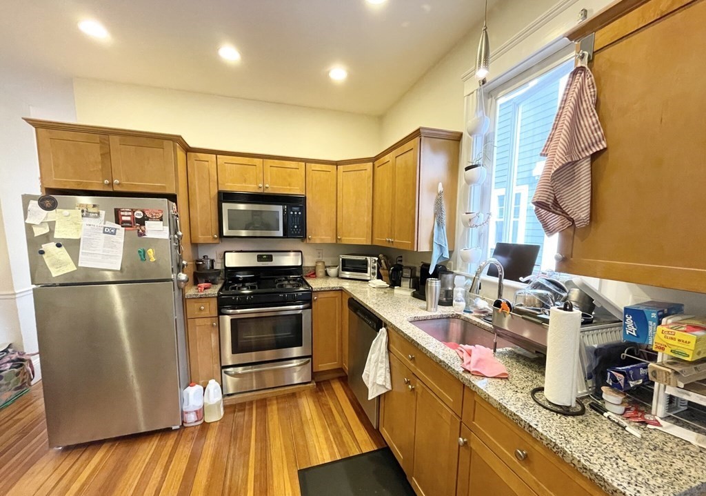 a kitchen that has a lot of cabinets a sink and appliances in it