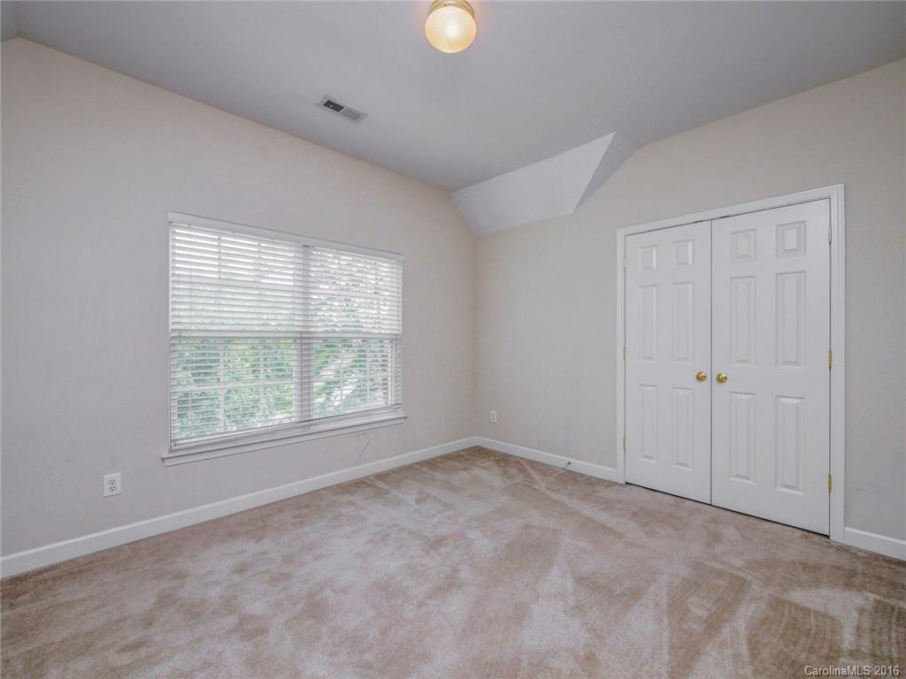 8319 Camberly Road Huntersville, NC 28078 - Photo 12 of 24 a view of an empty room with a window and cabinets