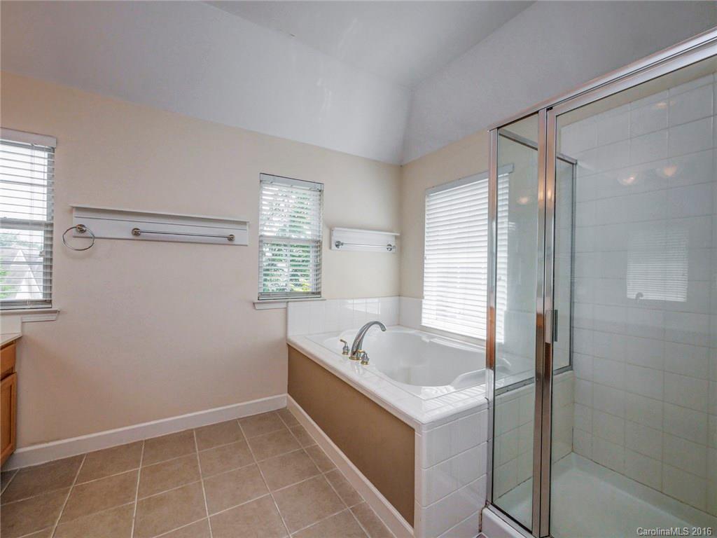 8319 Camberly Road Huntersville, NC 28078 - Photo 14 of 24 a bathroom with a tub a sink and window