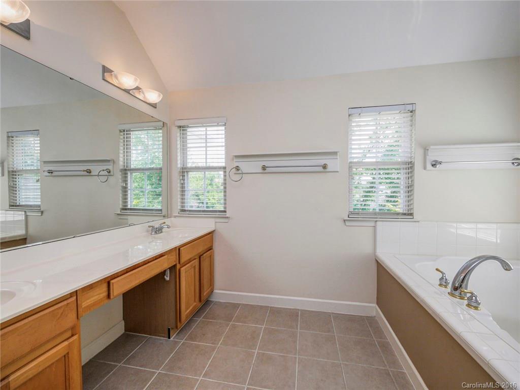 8319 Camberly Road Huntersville, NC 28078 - Photo 15 of 24 a bathroom with a tub sink and mirror