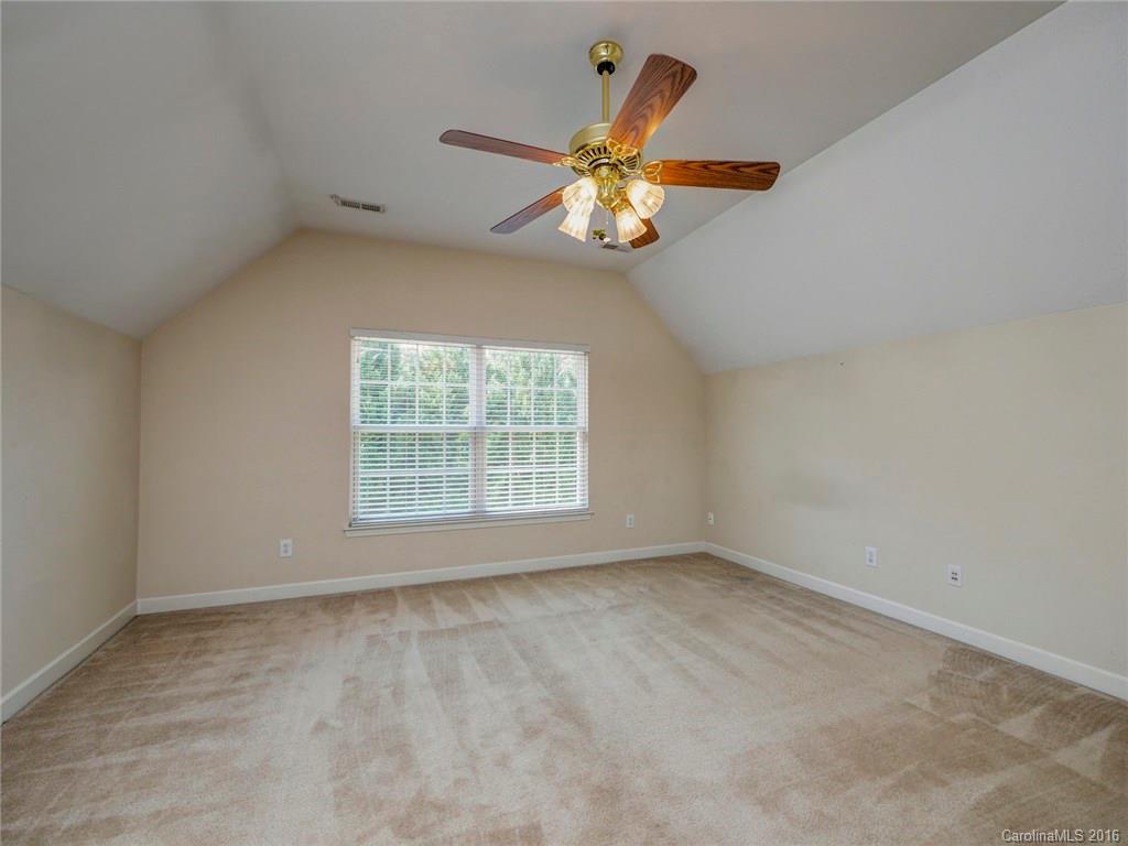 8319 Camberly Road Huntersville, NC 28078 - Photo 17 of 24 an empty room with a window and a ceiling fan