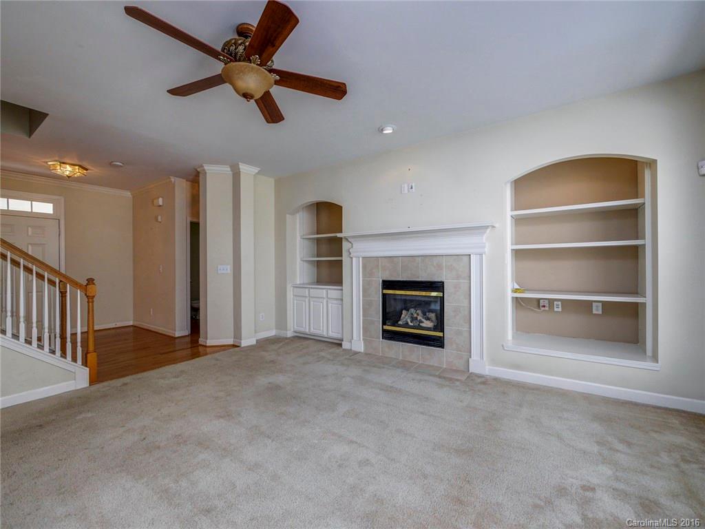 8319 Camberly Road Huntersville, NC 28078 - Photo 5 of 24 a view of an empty room with a fireplace and a window