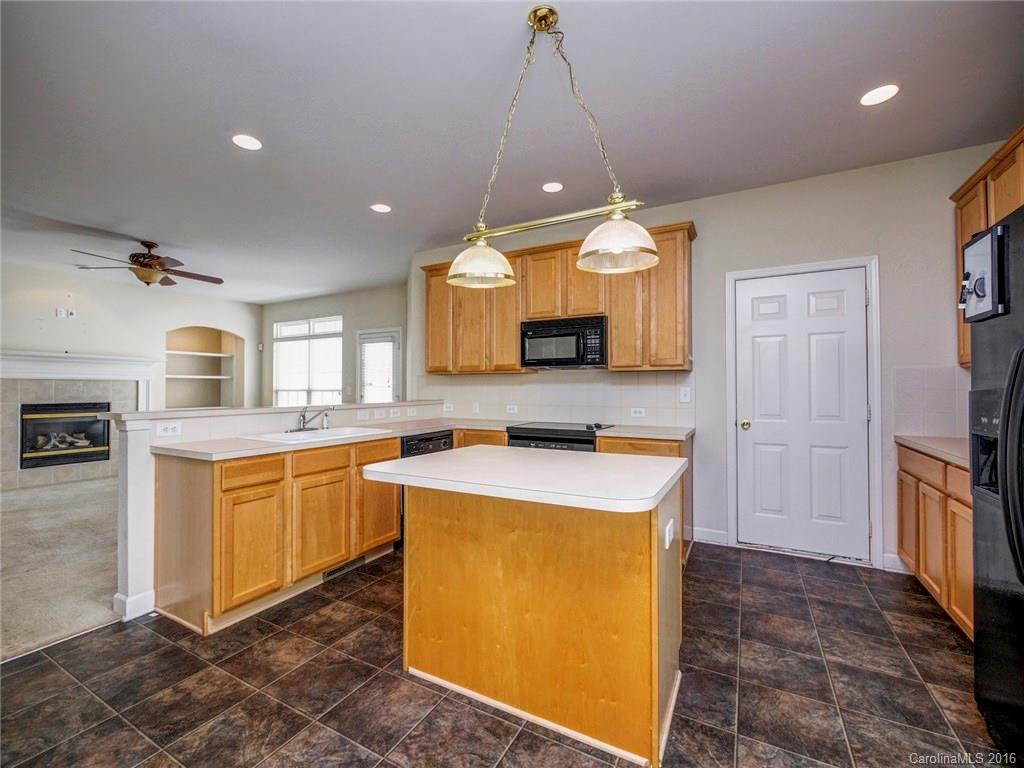 8319 Camberly Road Huntersville, NC 28078 - Photo 8 of 24 a kitchen that has a lot of cabinets in it and wooden floors
