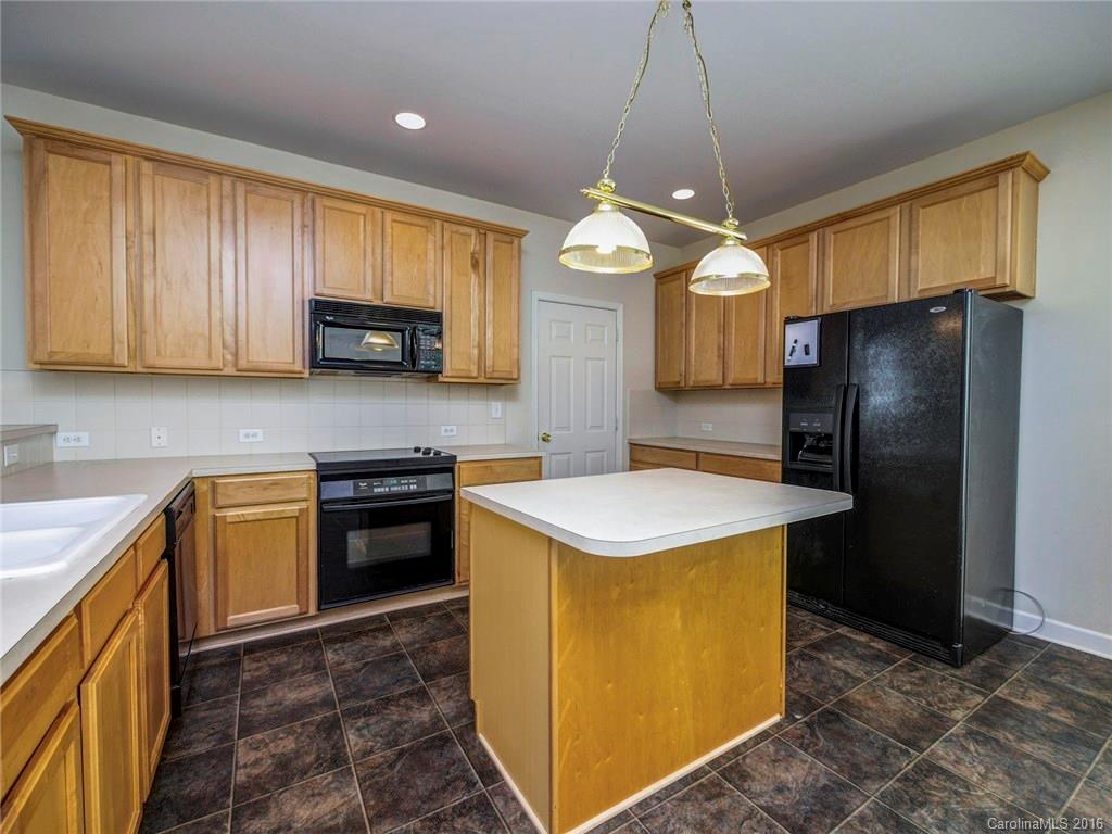 8319 Camberly Road Huntersville, NC 28078 - Photo 9 of 24 a kitchen with a stove a sink a refrigerator and a microwave