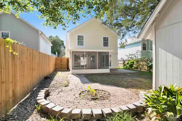 a view of a backyard with large trees and plants