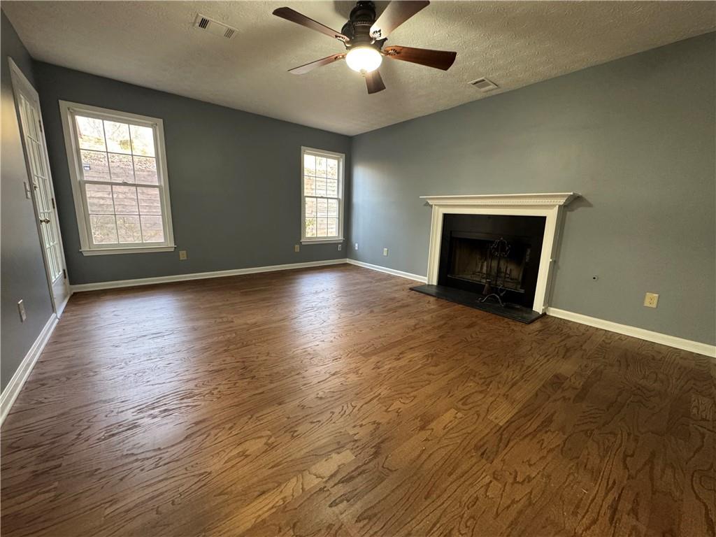 3205 Ivy Station Drive Duluth, GA 30096 - Photo 2 of 38 an empty room with windows fireplace and windows
