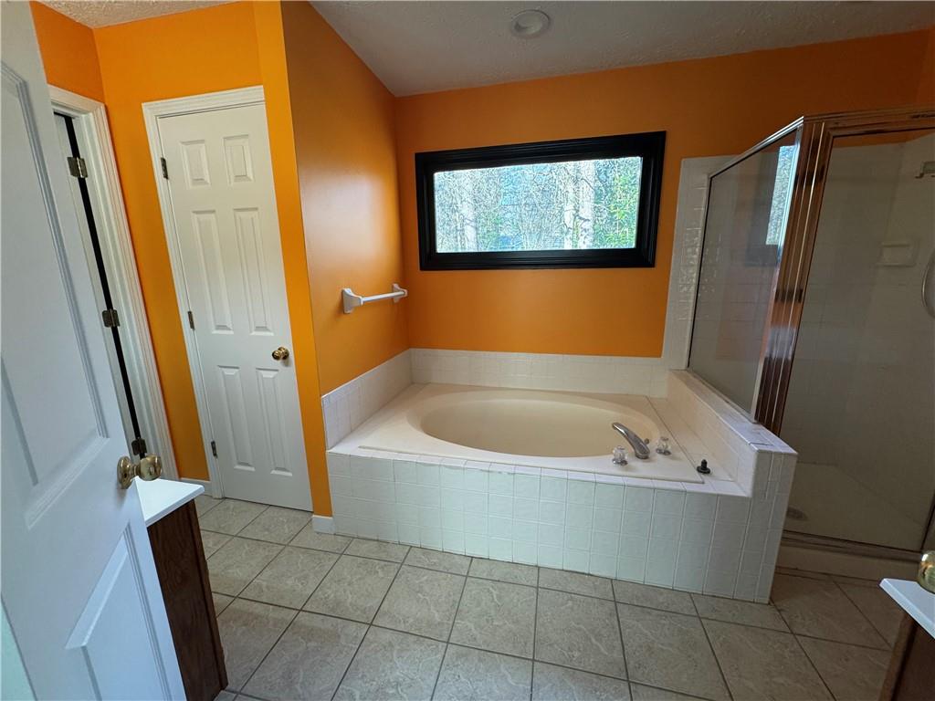 3205 Ivy Station Drive Duluth, GA 30096 - Photo 21 of 38 a bathroom with a tub a sink and a large mirror