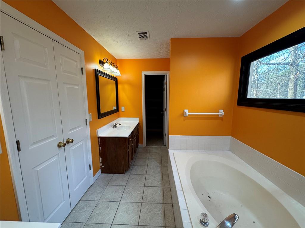 3205 Ivy Station Drive Duluth, GA 30096 - Photo 23 of 38 a bathroom with a bathtub and a shower