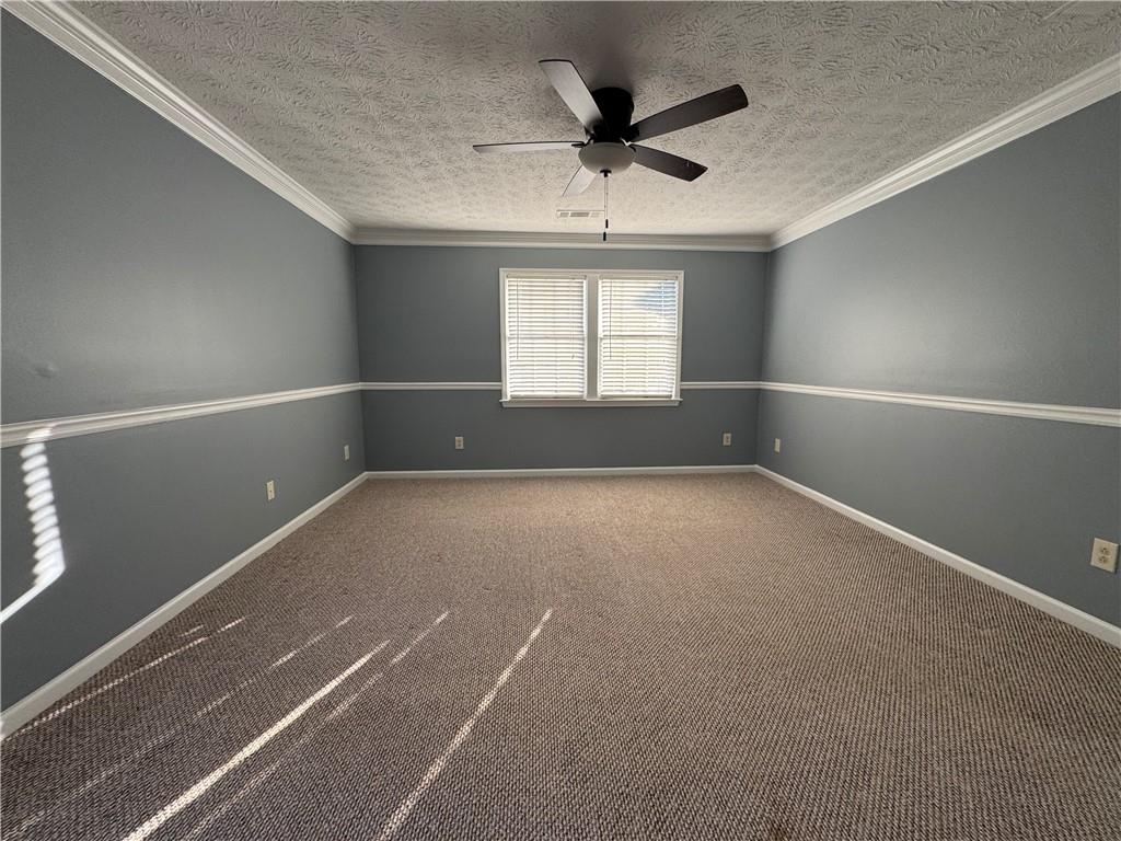 3205 Ivy Station Drive Duluth, GA 30096 - Photo 25 of 38 an empty room with a ceiling fan and window