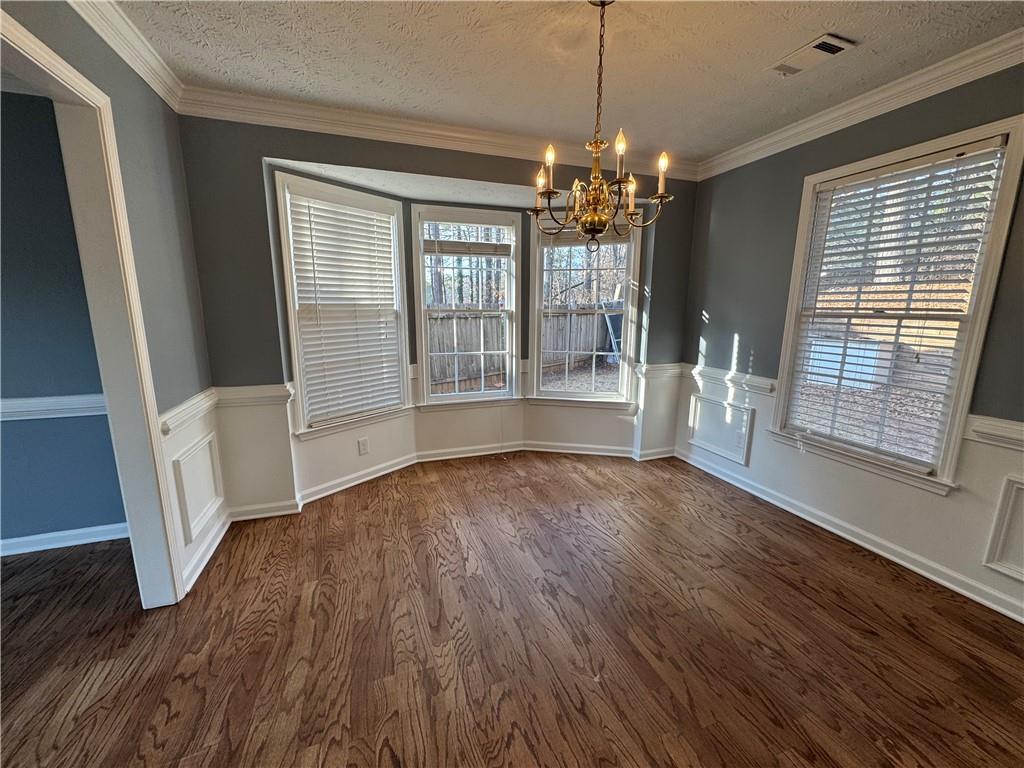 3205 Ivy Station Drive Duluth, GA 30096 - Photo 4 of 38 a view of an empty room with wooden floor and a window