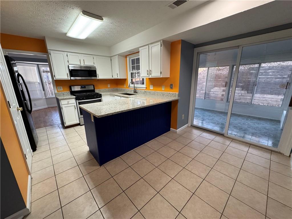 3205 Ivy Station Drive Duluth, GA 30096 - Photo 5 of 38 a kitchen with stainless steel appliances granite countertop a refrigerator and a stove top oven